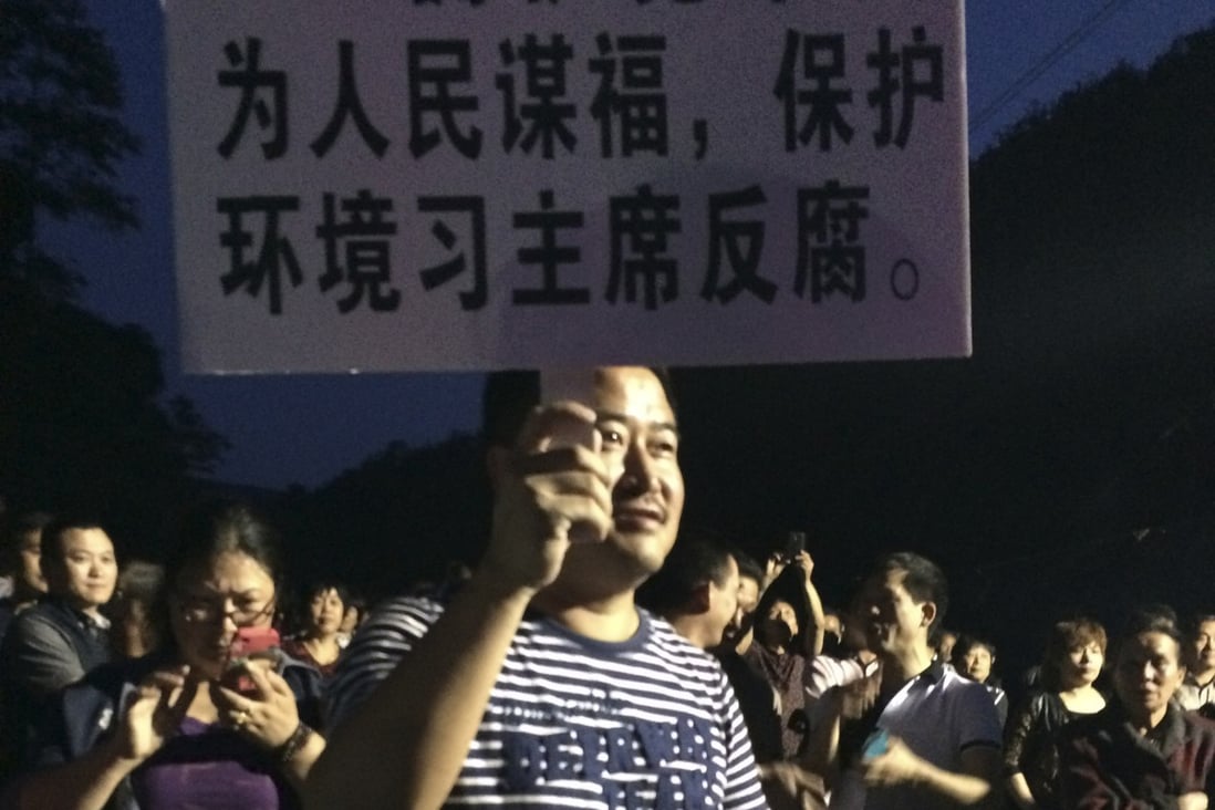 A demonstrator holds a placard during a protest against the construction of a waste incinerator in Hangzhou, Zhejiang province. Photo: Reuters