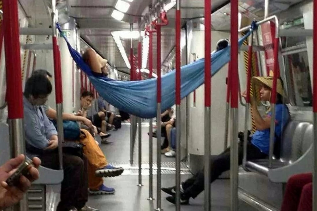 No one seems to notice as this brazen passenger takes a doze in a hammock strung between the seats of an Island Line train on Monday night. Photo: SCMP Pictures