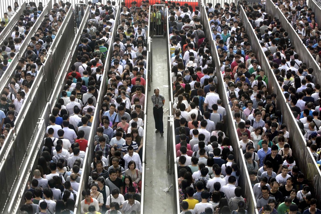 Passengers line up and wait for a security check during morning rush hour at Tiantongyuan North Station in Beijing. Photos: Reuters