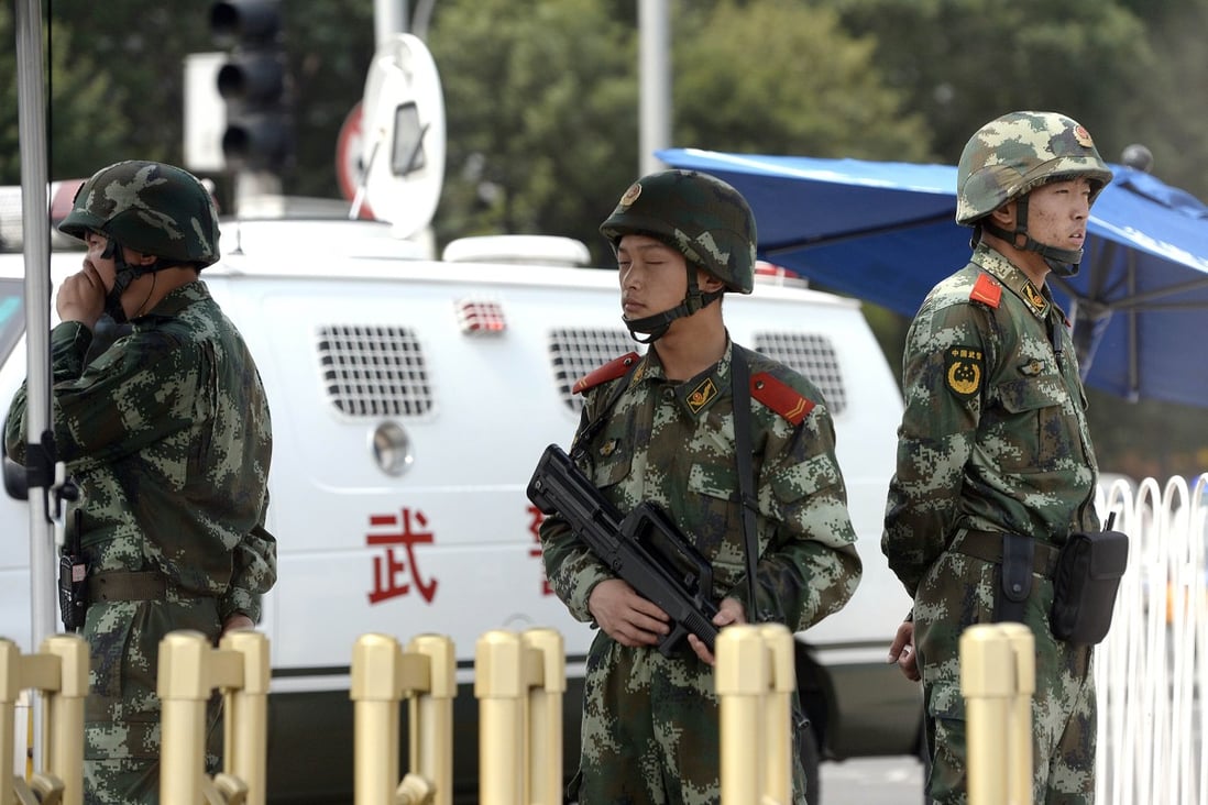 Paramilitary policemen stand guard next to police vehicles in Beijing. Photo: AFP
