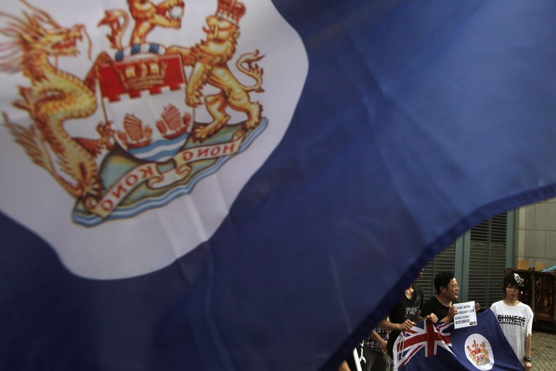 Protesters, carrying former Hong Kong colonial flags, demonstrate against China's intervention and control of the internal affairs of the former British colony, outside the British Consulate in Hong Kong. Photo: Reuters