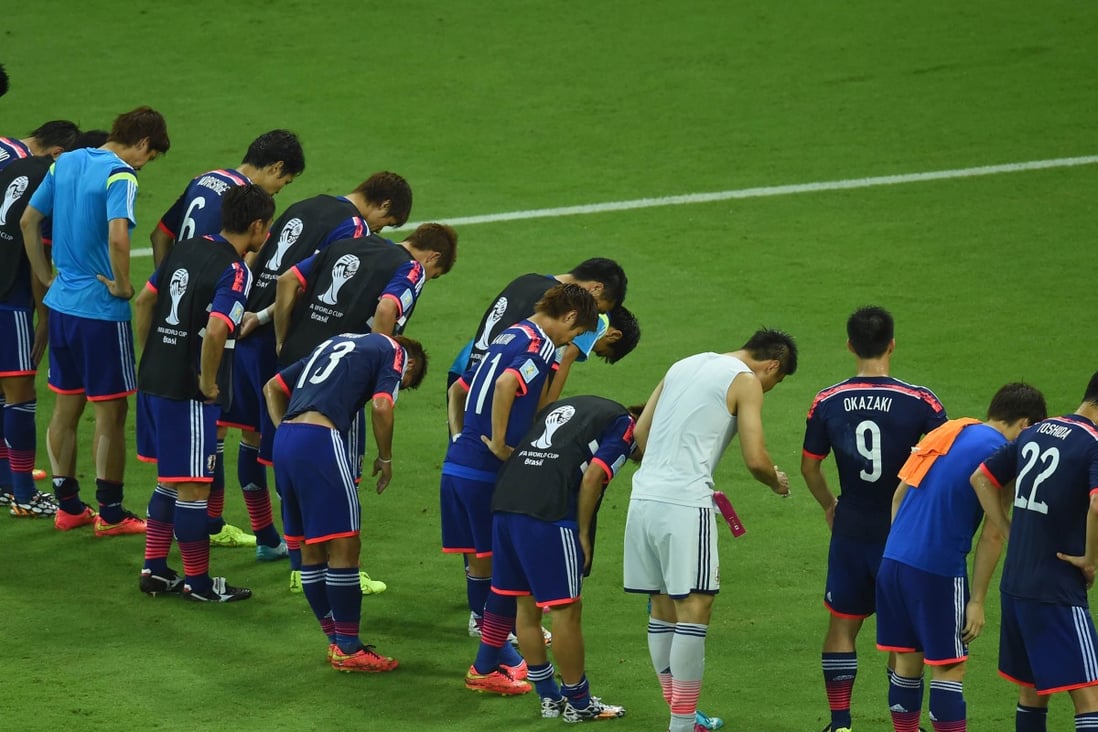 Members of the Japanese team bow to their fans after the match against Ivory Coast during the 2014 FIFA World Cup. Photo: AFP