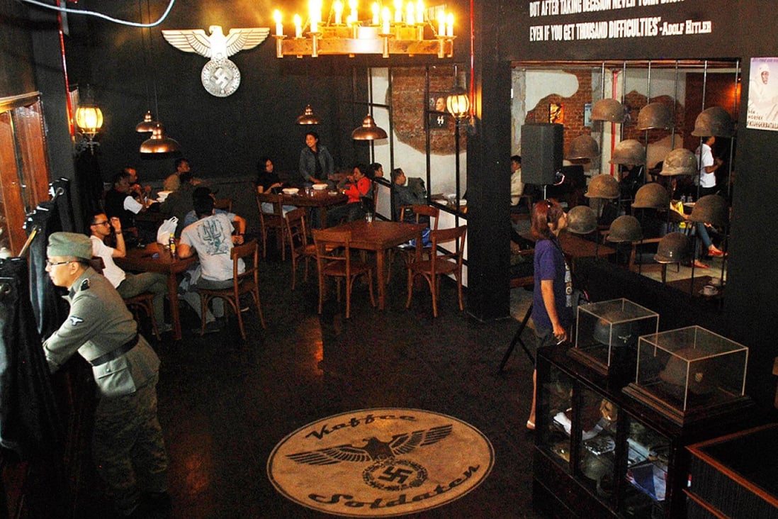 A Nazi swastika insignia sign on the floor decorates the interior of the reopened SoldatenKaffee in Bandung, western Java on Saturday. Photo: AFP