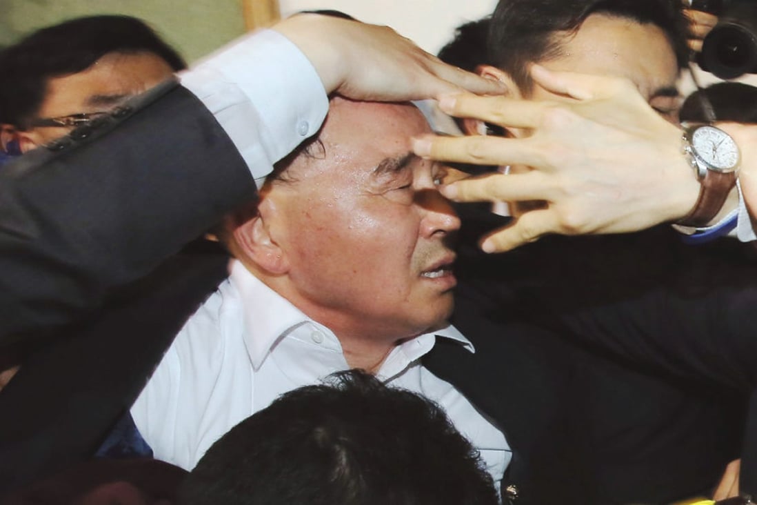 South Korean Prime Minister Chung Hong-won is shielded by bodyguards from angry relatives of Sewol ferry passengers in April. Photo: AP