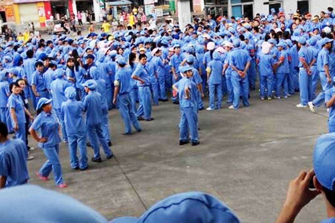 Workers gather in front of their factory in Dongguan after calling their strike. Photo: SCMP Pictures