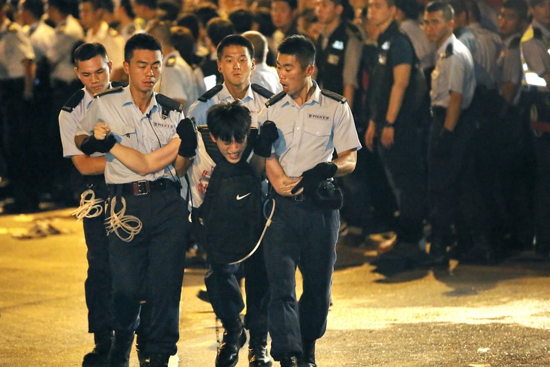 A protester is dragged away by police in Central after hundreds of demonstrators staged a sit-in overnight. Photo: AP 