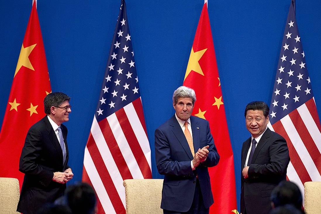 US Secretary of State John Kerry (centre) applauds next to President Xi Jinping in Beijing as Jack Lew looks on. Photo: Reuters
