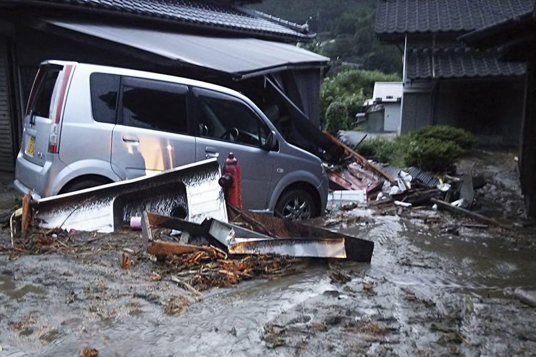Cars and buildings damaged by a landslide caused by heavy rains set off by Typhoon Neoguri are seen in Nagiso. Photo: Reuters