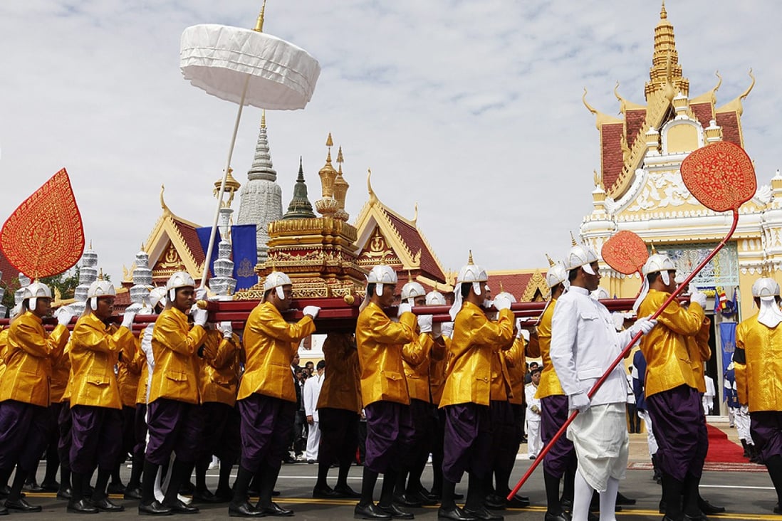 Cambodian officials carry urns containing ashes of former King Norodom Sihanouk during a parade in Phnom Penh on Friday. Photo: EPA
