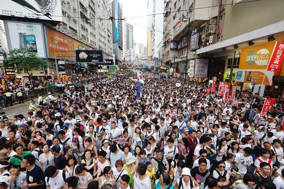 Pro-democracy protesters march through the streets of Hong Kong on July 1. Photo: AP