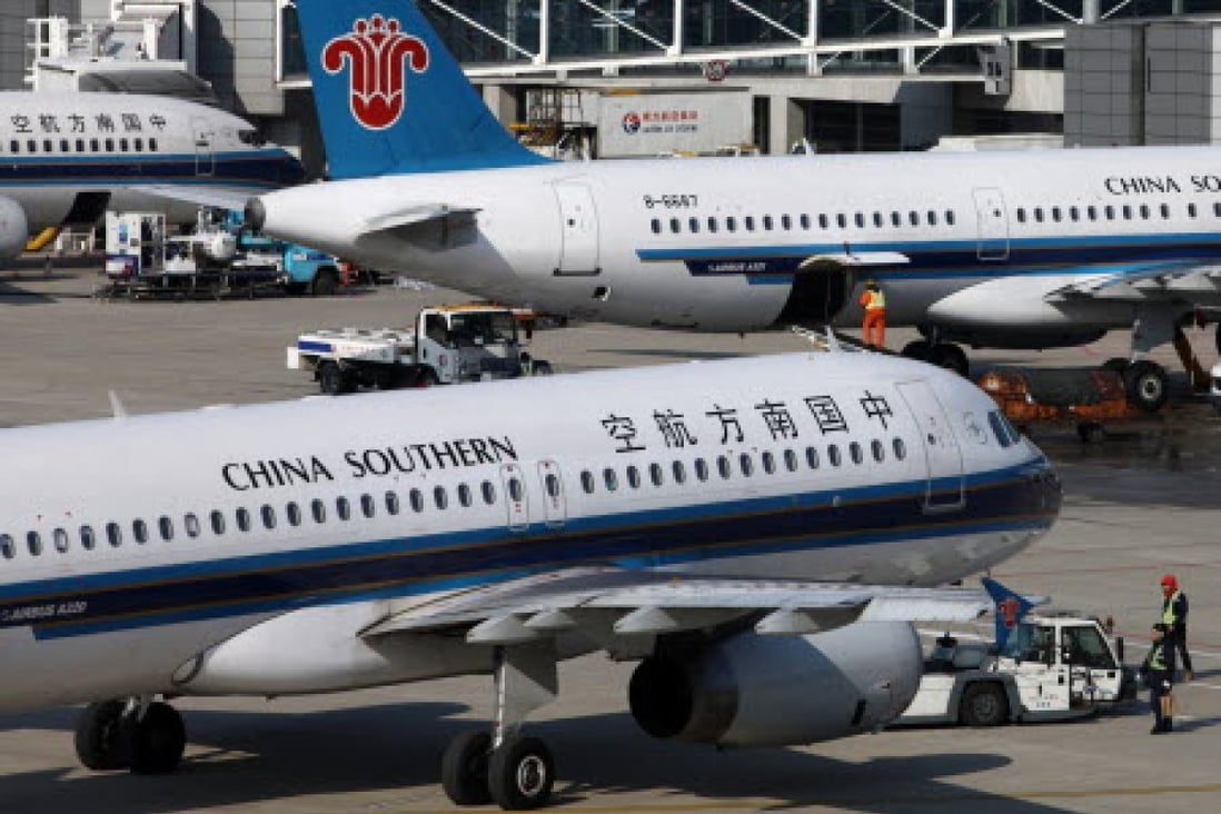 China Southern aircraft are parked at Pudong airport in Shanghai. More than 100 flights were either delayed or cancelled at Pudong and Hongqiao airports today. Photo: Bloomberg