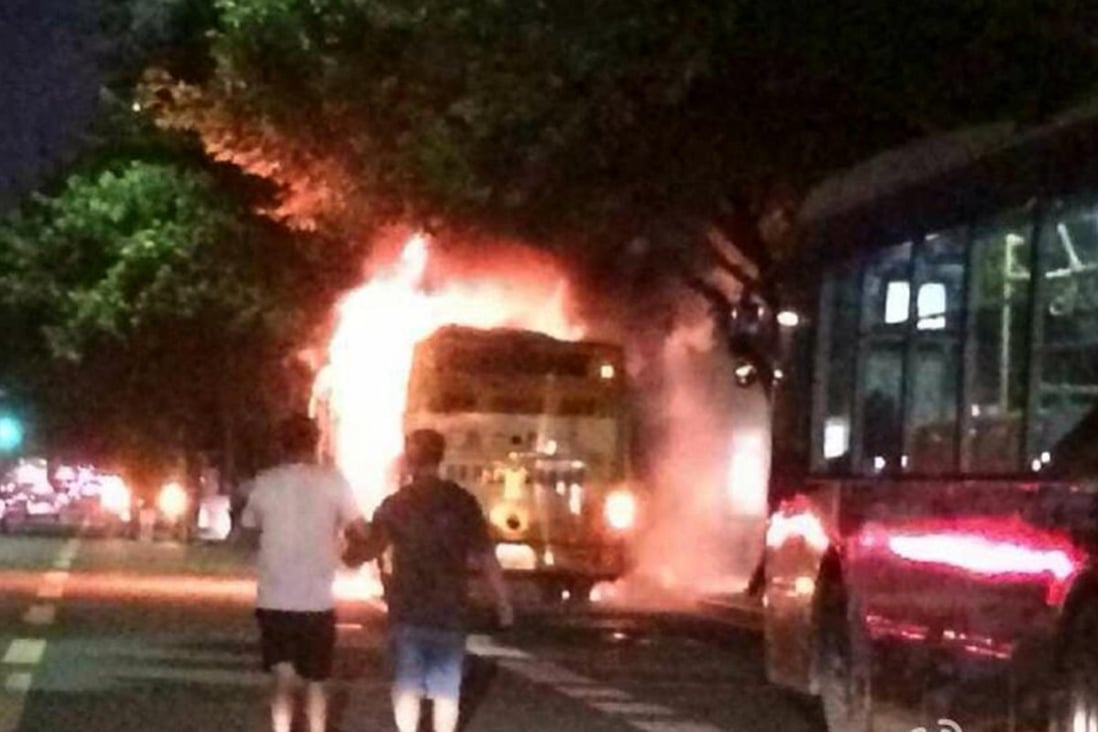 The bus is engulfed in flames near Nandunhe Bus Station on Guangzhou Avenue last night. Photo: SCMP Pictures