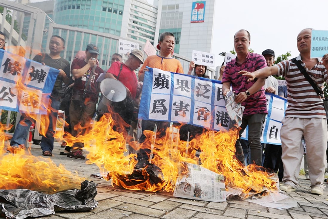 Protesters burn newspapers outside the Apple Daily headquarters in Tseung Kwan O. Photo: Sam Tsang