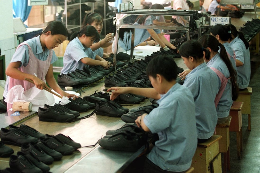 Workers toil in a Shenzhen shoe factory.