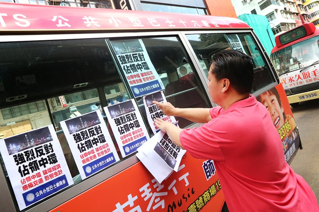 Minibus drivers attach anti-Occupy posters to their vehicles during Tuesday's protest in Mong Kok. Photo: David Wong