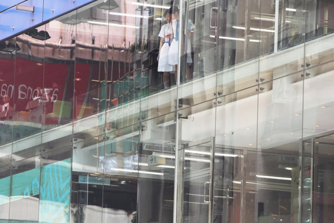 Some public buildings in Hong Kong have installed panels and opaque stickers on glass walls and staircases to alert women of the potential danger of upskirt photos. Photo: Sam Tsang