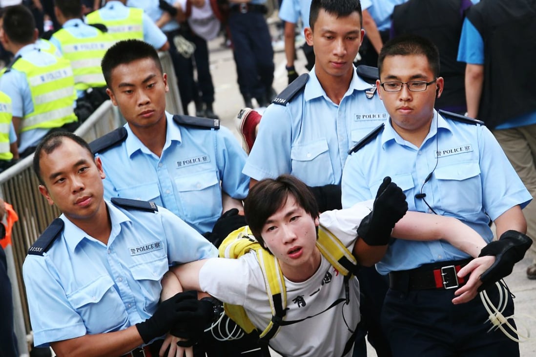 A protester is carried away by police during a protest sit-in last month. Photo: David Wong