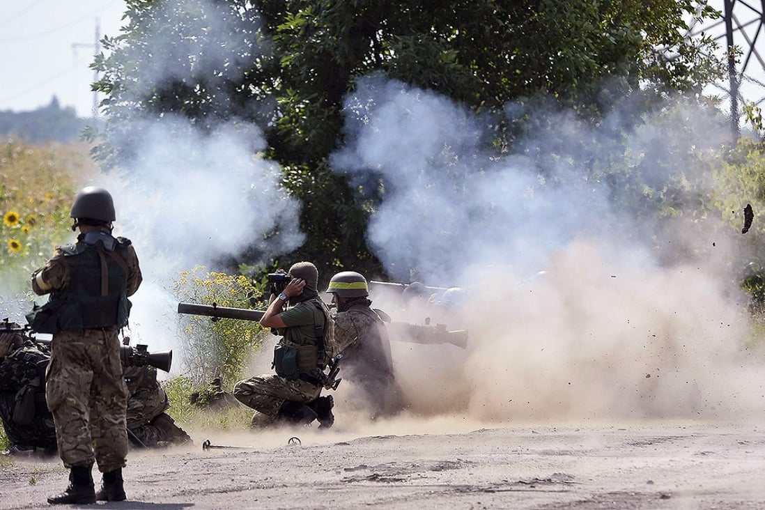 Ukrainian soldiers fire on the position of pro-Russian separatists near Lugansk on Friday. Photo: EPA