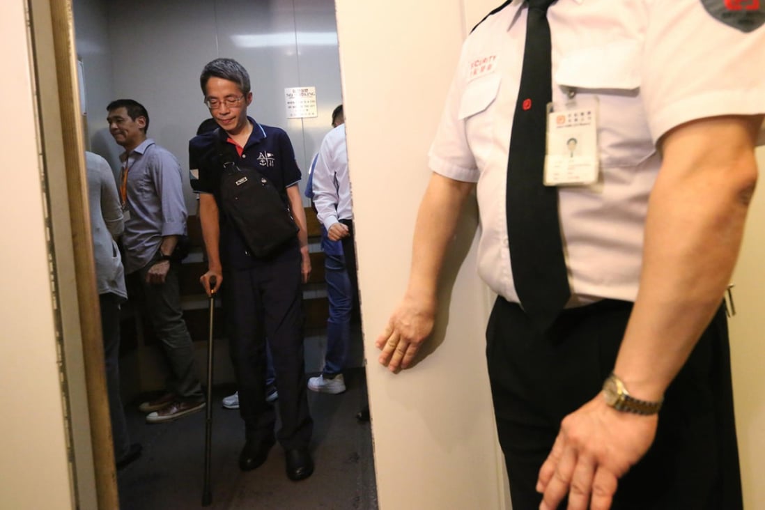 Kevin Lau relies on a crutch as he returns to the offices of Ming Pao for the first time since the attack in February. Photo: Felix Wong