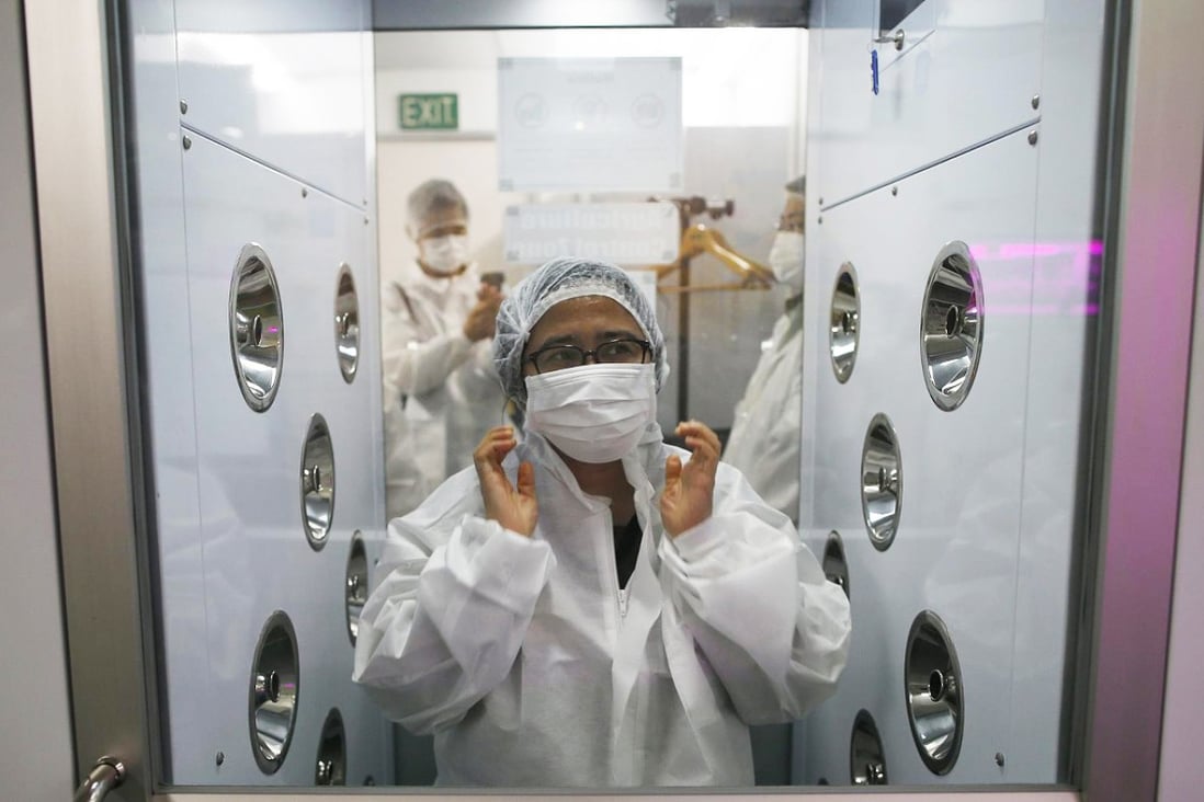 A visitor suits up before entering Panasonic's vegetable farm. Photo: Reuters