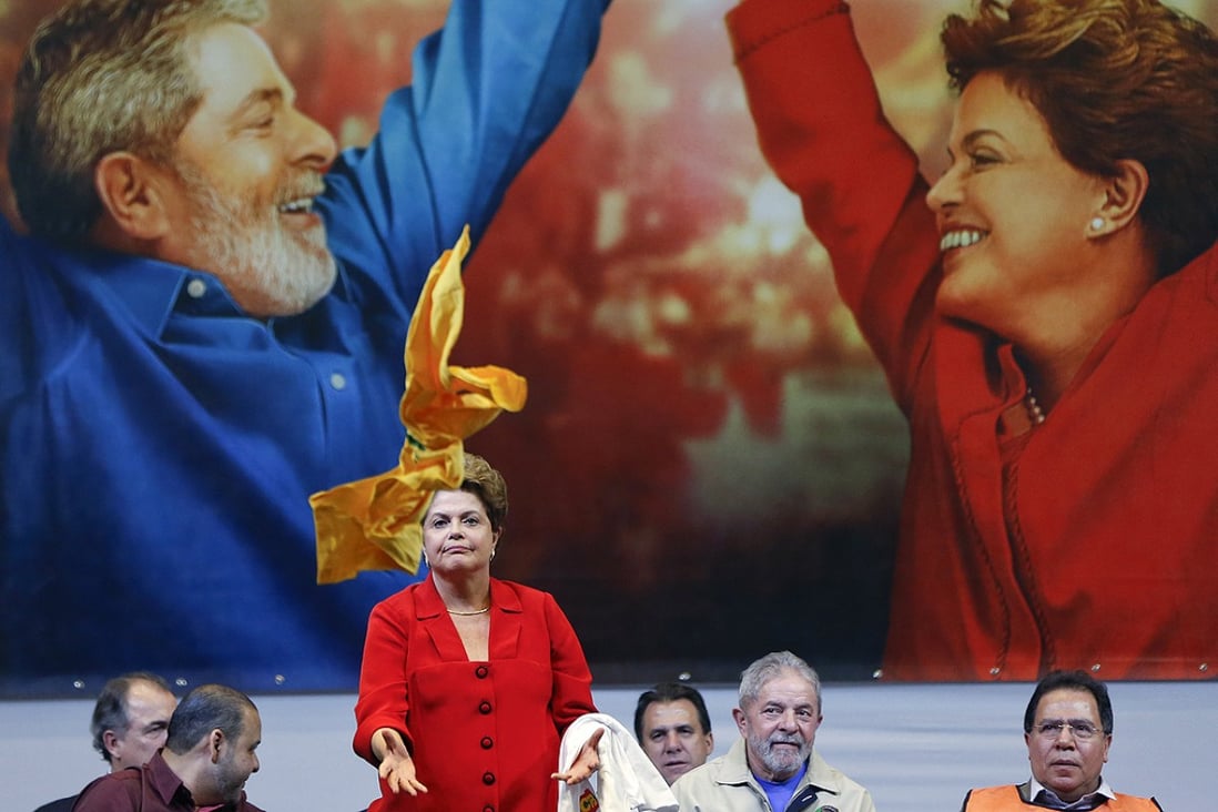 Former Brazilian leader Luiz Ignacio Lula da Silva (second right) watches as Brazil's President Dilma Rousseff catches a shirt thrown to her by a supporter during an election campaign rally in Sao Paulo, Brazil on Thursday. Photo: AP