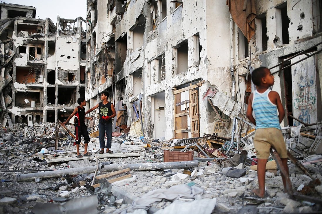 Palestinian boys play among the rubble hours before a 72-hour ceasefire between Israel and Hamas will come to an end in the northern Gaza Strip. Photo: EPA