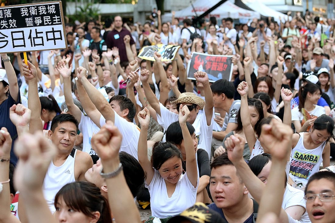 A SCMP study found it would take more than 11,000 people just to occupy Chater Road, based on protesters locking arms, as they did in a July 2 sit-in protest there. Photo: K.Y. Cheng