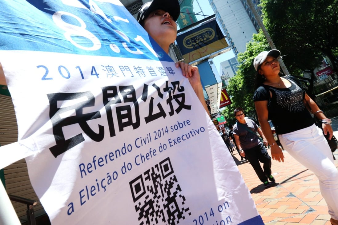 Concern group hold banner to urge people to vote in an civil referendum in Macau. Photo: K.Y. Cheng