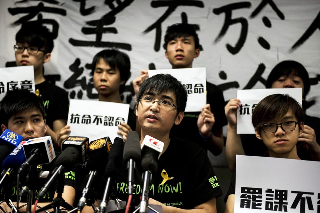 Alex Chow (centre) secretary general of the Hong Kong Federation of Students, speaks at a press conference announcing the boycott. Photo: AFP