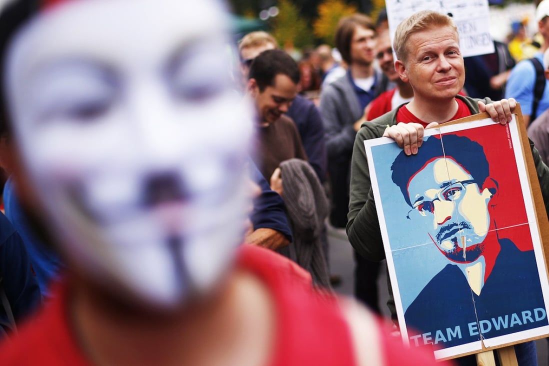 A man holds a placard with a portrait of Edward Snowden during a "Freedom instead of Fear" protest calling for the protection of digital data privacy and the reigning in of digital surveillance practices, in Berlin on August 30, 2014. Photo: Reuters