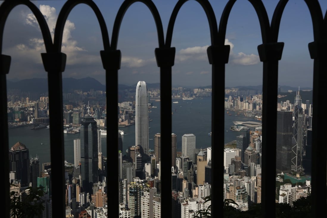 The skyline of Hong Kong is seen through a fence at the Peak in Hong Kong September 10, 2014. Photo: Reuters