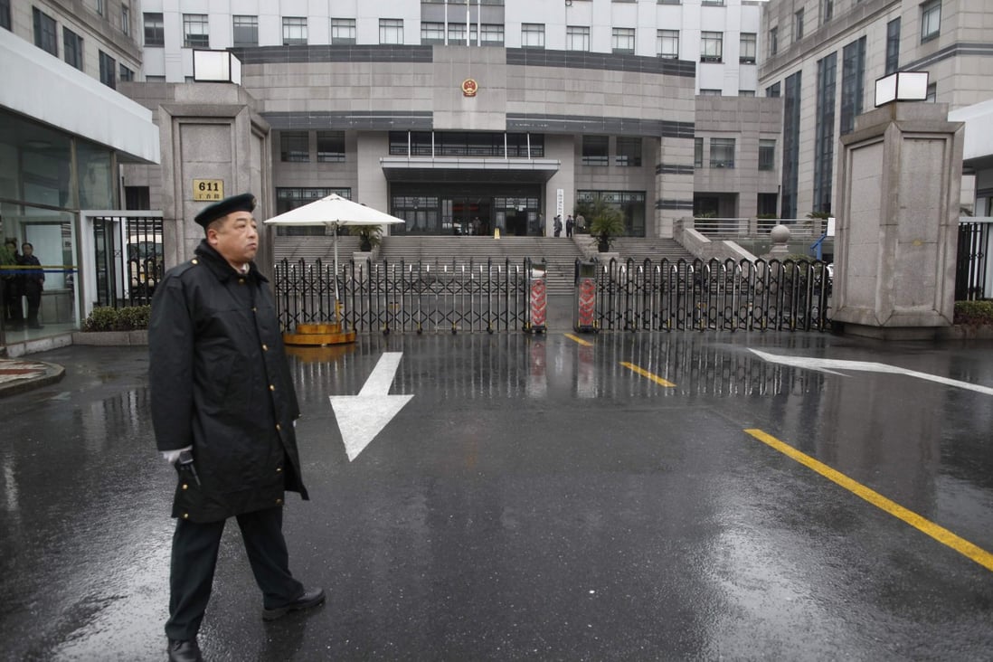 A security guard stands in front of the Shanghai Pudong New Area People's Court in Shanghai. Photo: Reuters