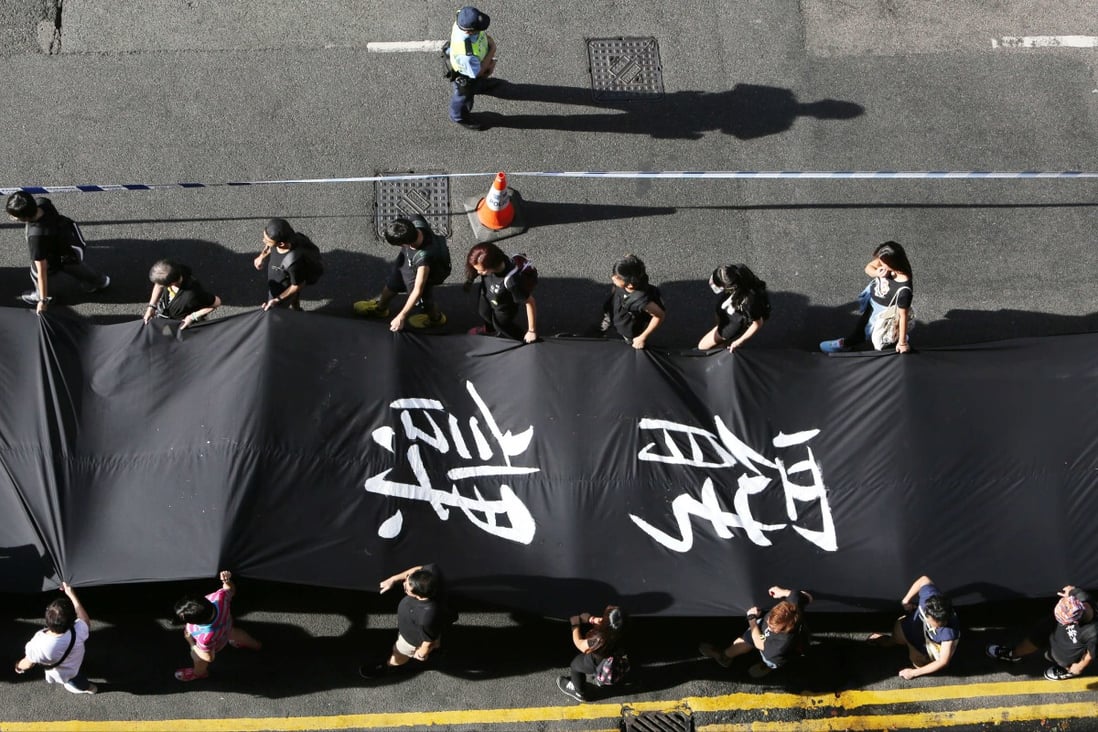Protestors hold Black Cloth match to Chater Road from Causeway Bay during Occupy Central with Love and Peace conduct a "Black Cloth March" on Sunday. Photo: Felix Wong
