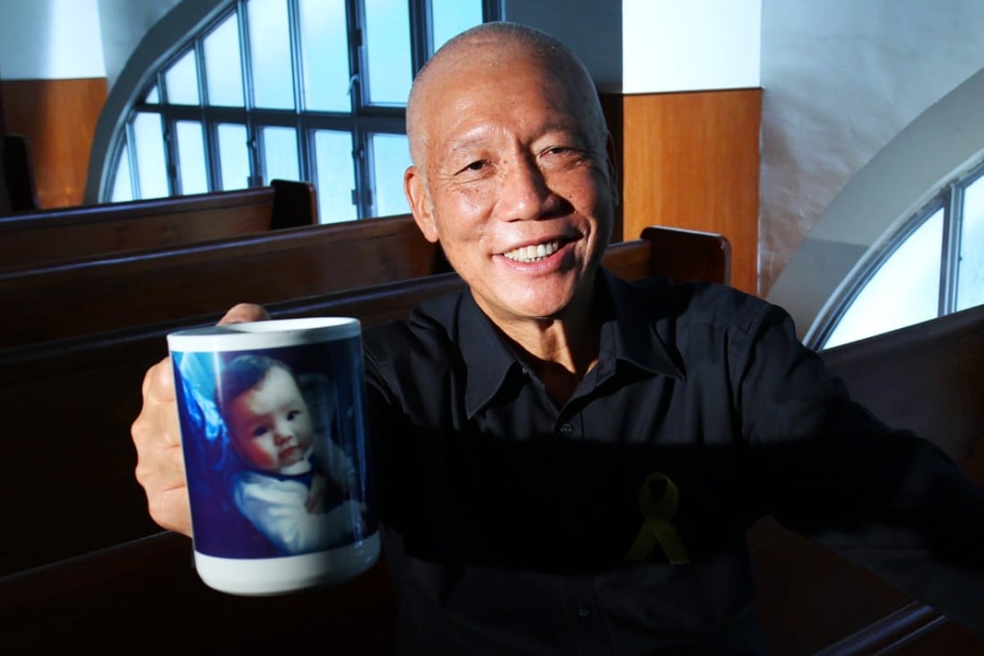 Reverend Chu Yiu-ming raises a mug bearing a picture of his granddaughter. He hopes democracy will bring a better future. Photo: Dickson Lee