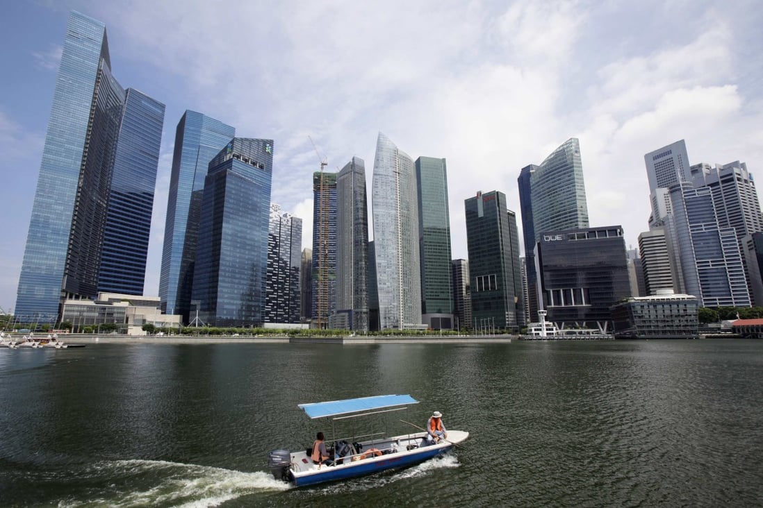 Boat manoeuvres in front of skyscrapers of Marina Bay Financial Centre in Singapore. Photo: Reuters
