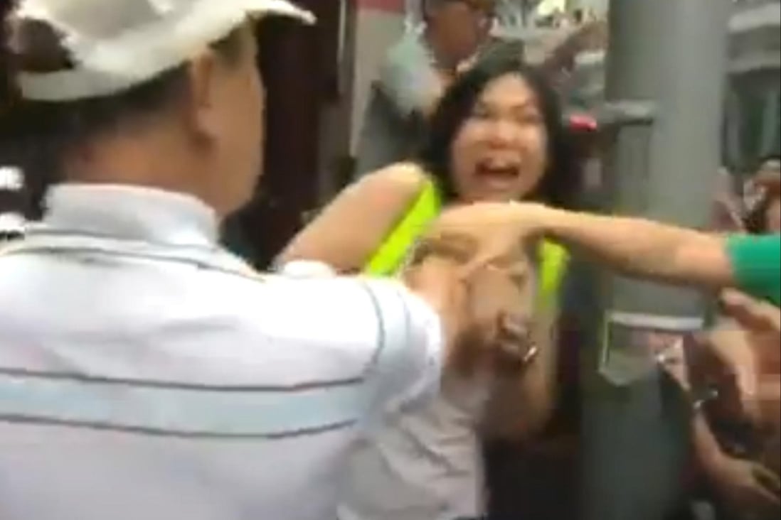 A still from a video shows a man groping a woman in Mong Kok.