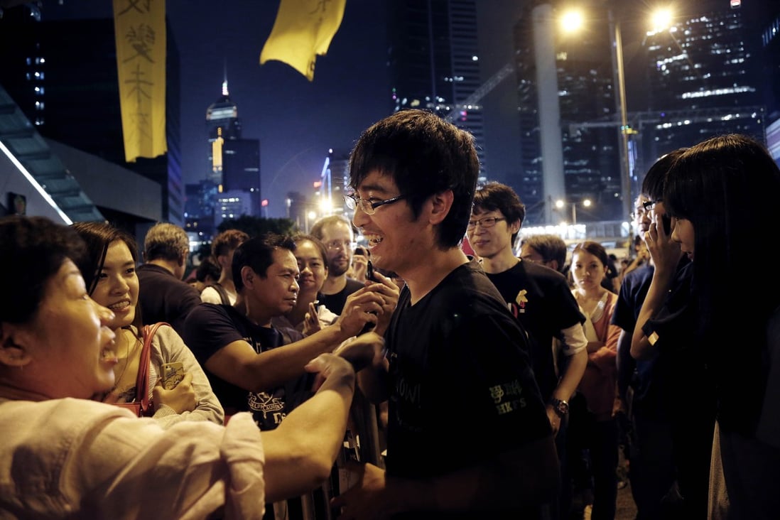 Pro-democracy supporters encourage student leader Alex Chow at a rally on Monday. Photo: AP