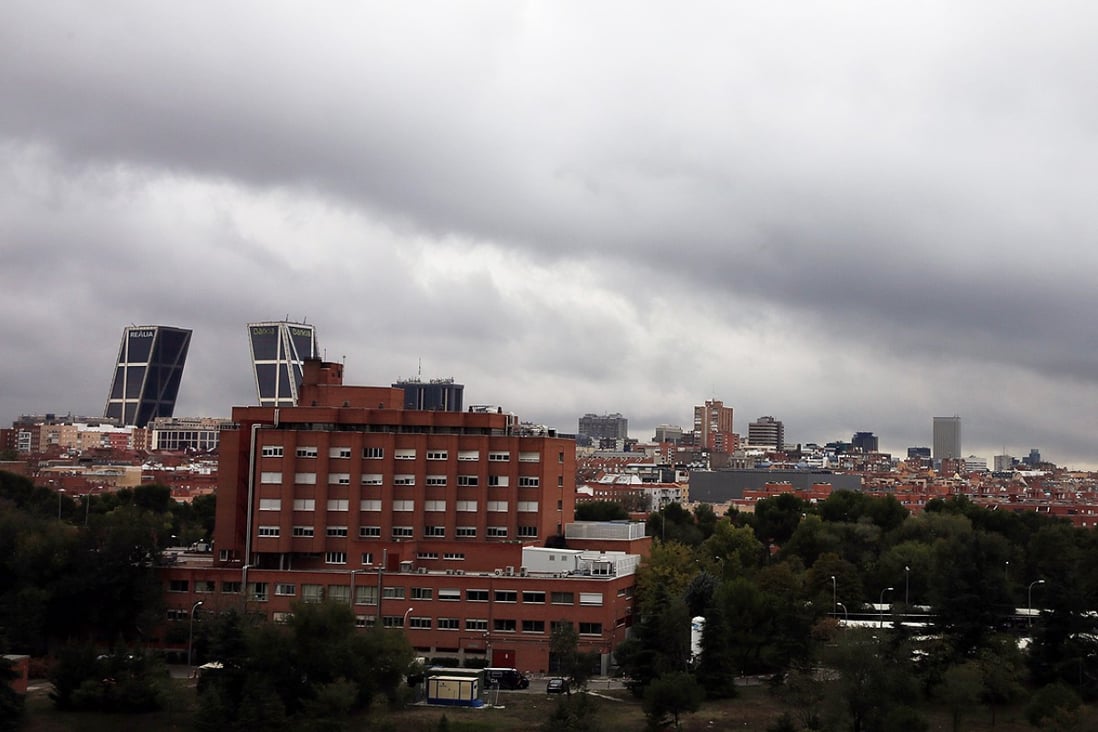 Rain clouds pass over Madrid's Carlos III Hospital, where Spanish nurse Teresa Romero Ramos who contracted Ebola is hospitalised with 16 others under observation. Photo: Reuters