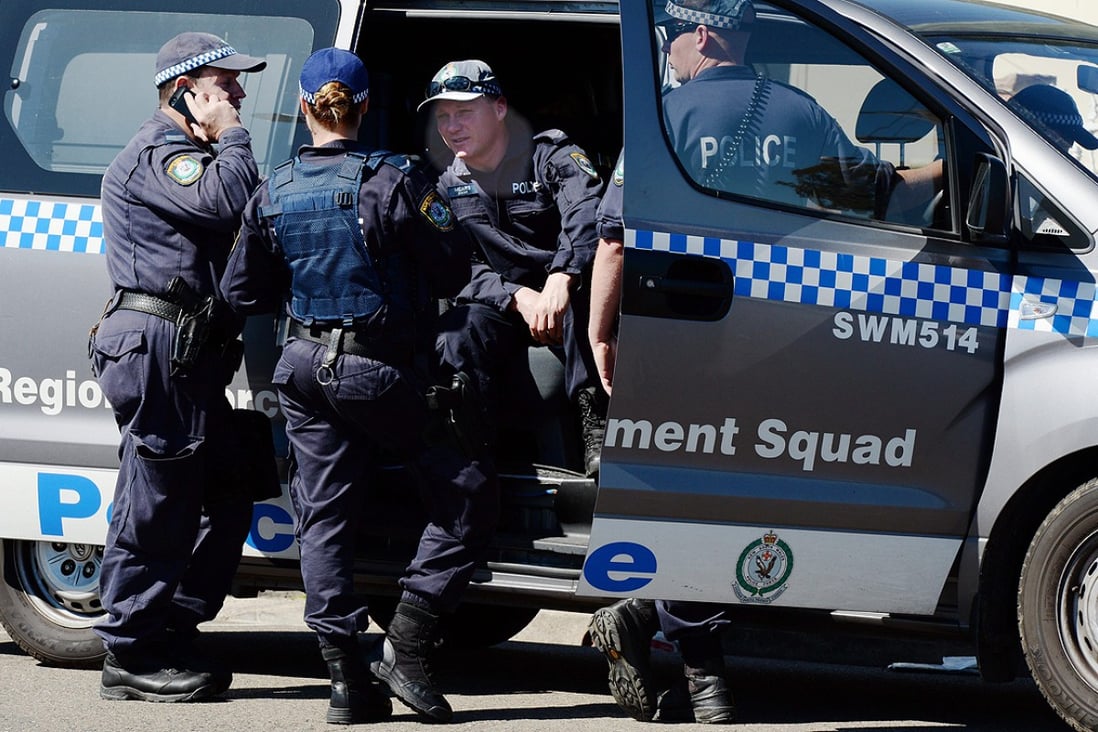 NSW Police and Australian Federal Police officers raid a house in Guildford, Sydney on September 18. Photo: EPA