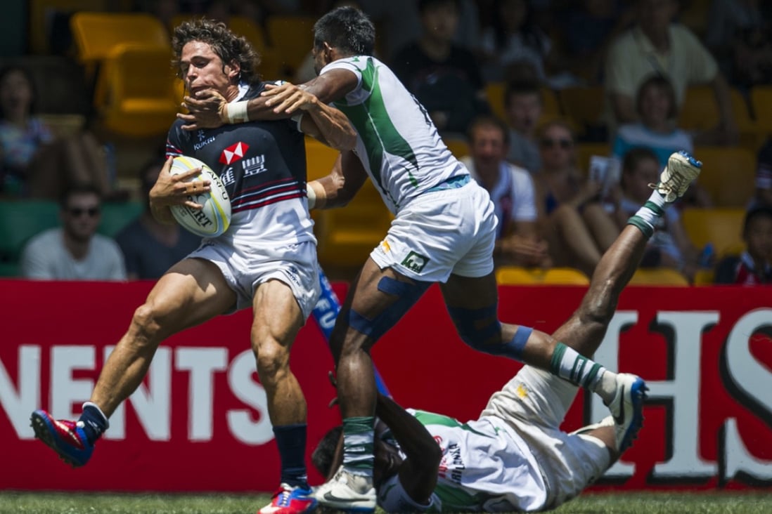 Rowan Varty runs into trouble against Sri Lanka in the Hong Kong Asian Sevens men’s semi-finals, but the hosts powered through and took maximum points from the first stop on the 2014 Asian Sevens Series. Photo: Power of Sport Images for HKRFU