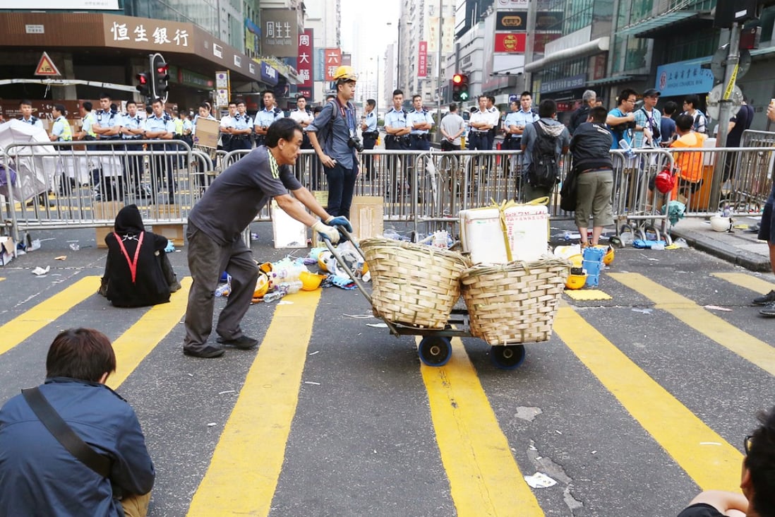 A man pushes a handcart at a protest site in Mong Kok. Police have accused protesters of using children as "human shields". Photo: K.Y. Cheng