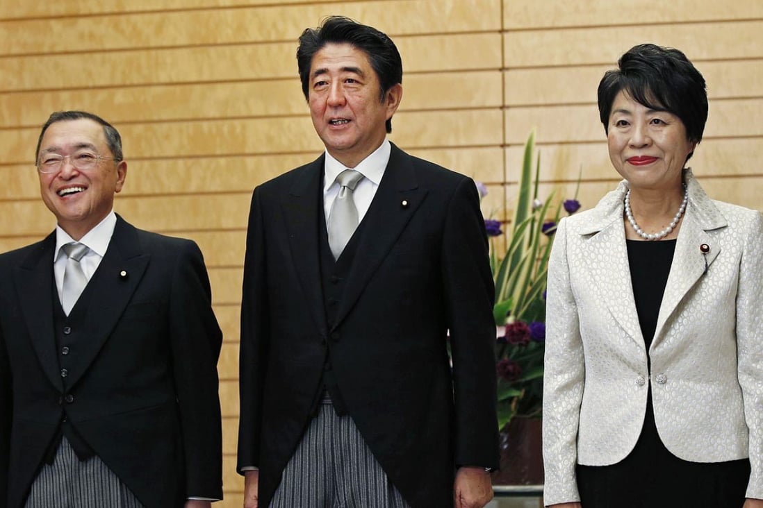 Shinzo Abe (centre) poses with Yoichi Miyazawa (left) and Yoko Kamikawa. Photo: Reuters