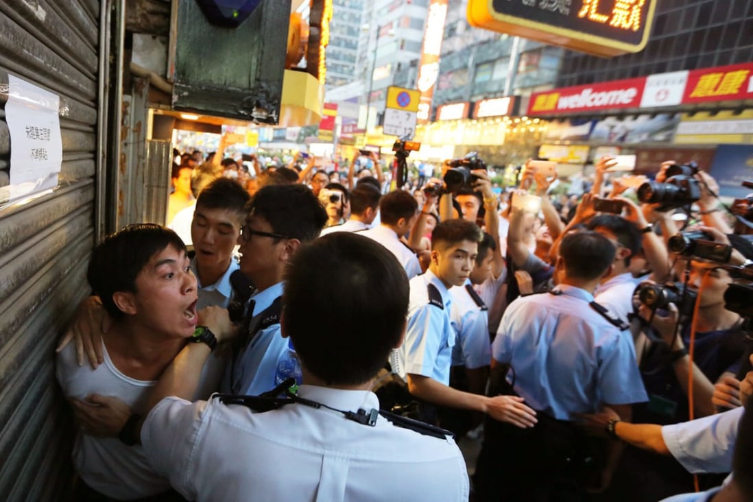 Police arrest an activist in Mong Kok during Occupy Central movement. Photo: Sam Tsang