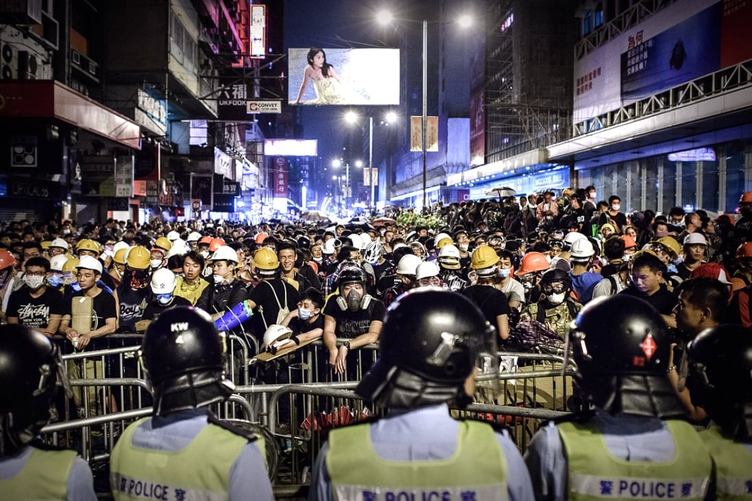 Riot police and protesters face off in Mong Kok on October 19. Photo: AFP