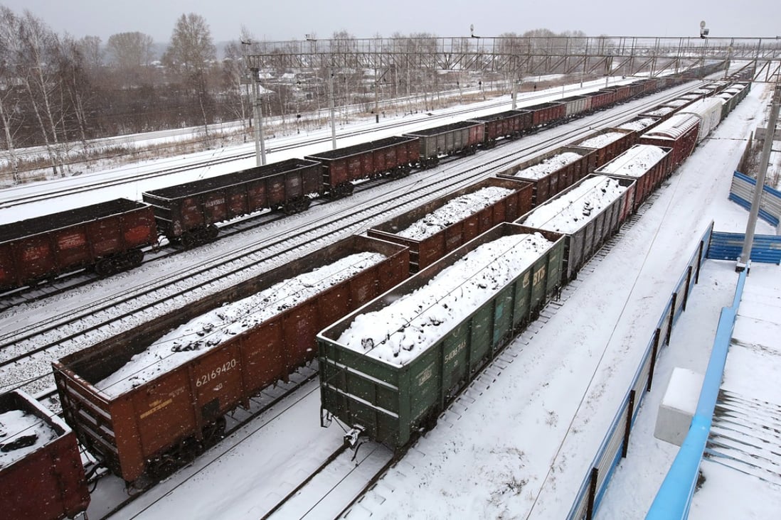 Snow covered freight wagons loaded with coal stand in sidings on the Trans-Siberian railroad in the Kemerovo region of Siberia near Yashkino, Russia on October 24, 2014. Photo: Bloomberg