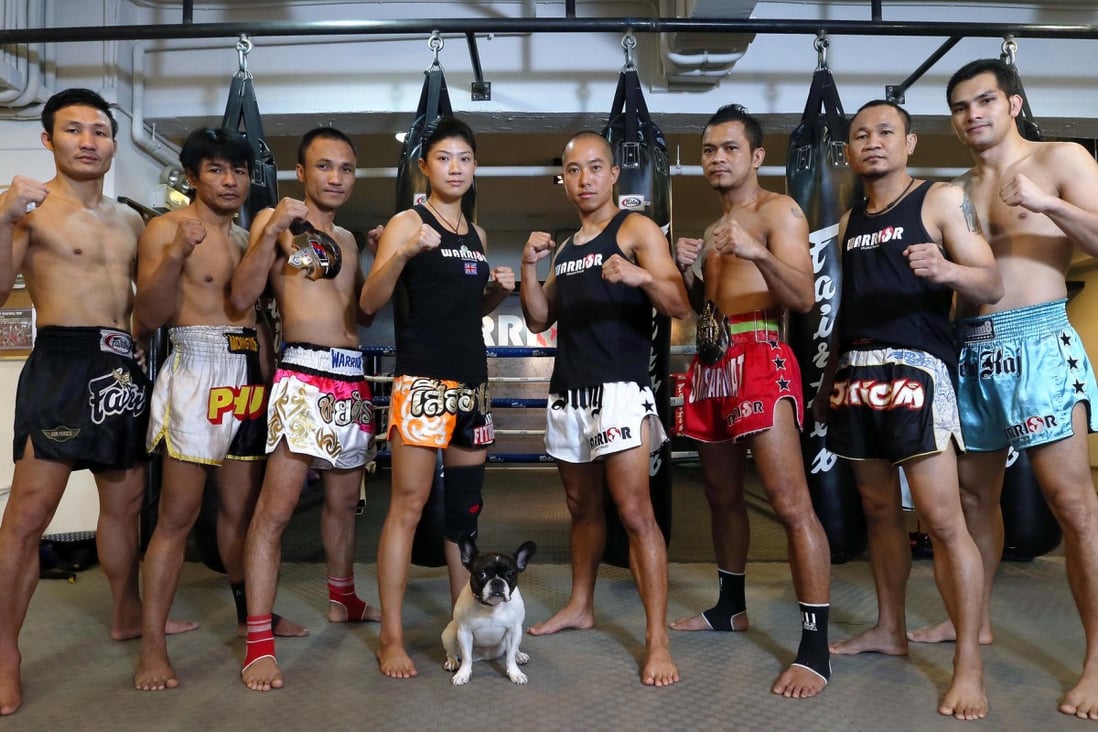 Warrior Muay Thai trainers (from left) Bird, Phut, Nom, Purcell Tong, co-founder Billy Tam, Tam, Bhurm and Keng and Maya, the gym's mascot. Photo: K.Y. Cheng