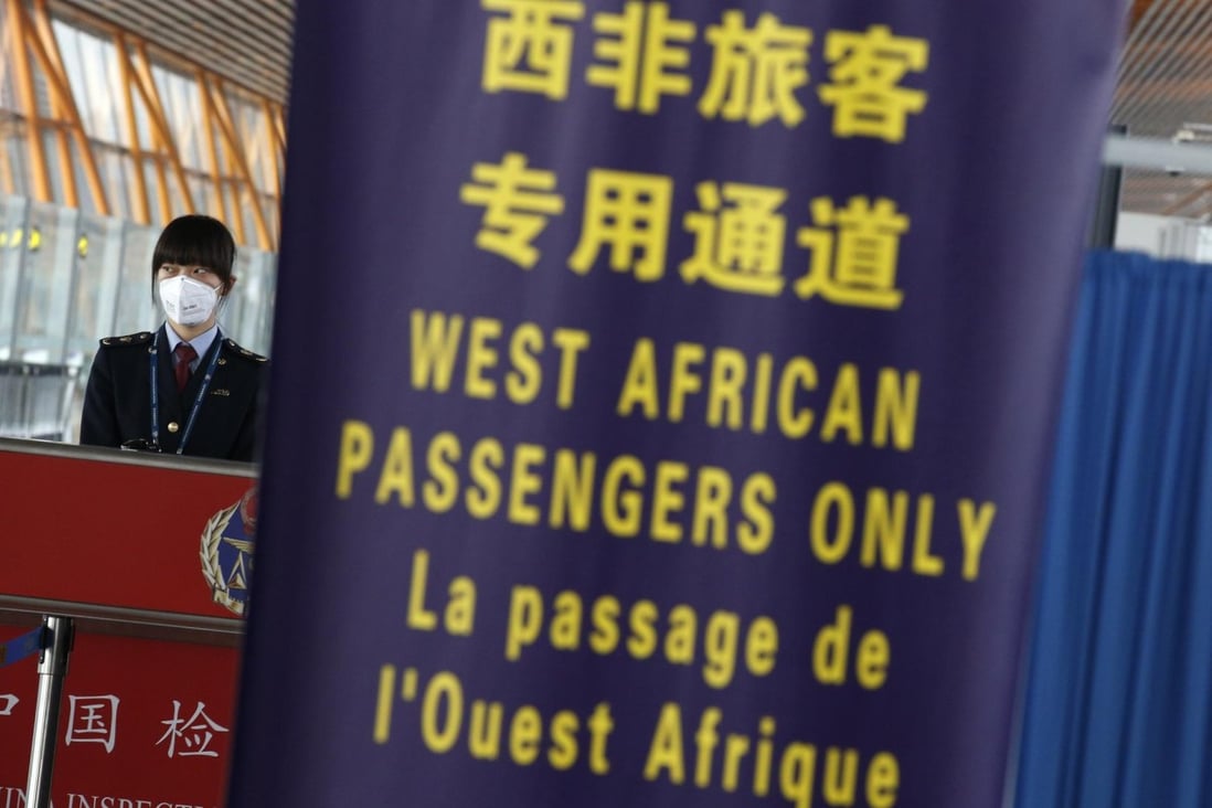 A quarantine official stands at a lane reserved for nationals from West African countries hit by the Ebola virus, at Beijing Capital International Airport. Photo: Reuters