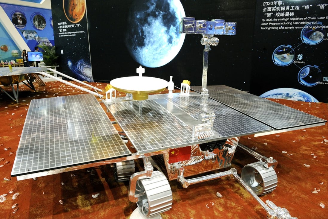 Visitors look at a prototype model of a Mars rover on display at the China International Industry Fair in Shanghai. Photo: Xinhua