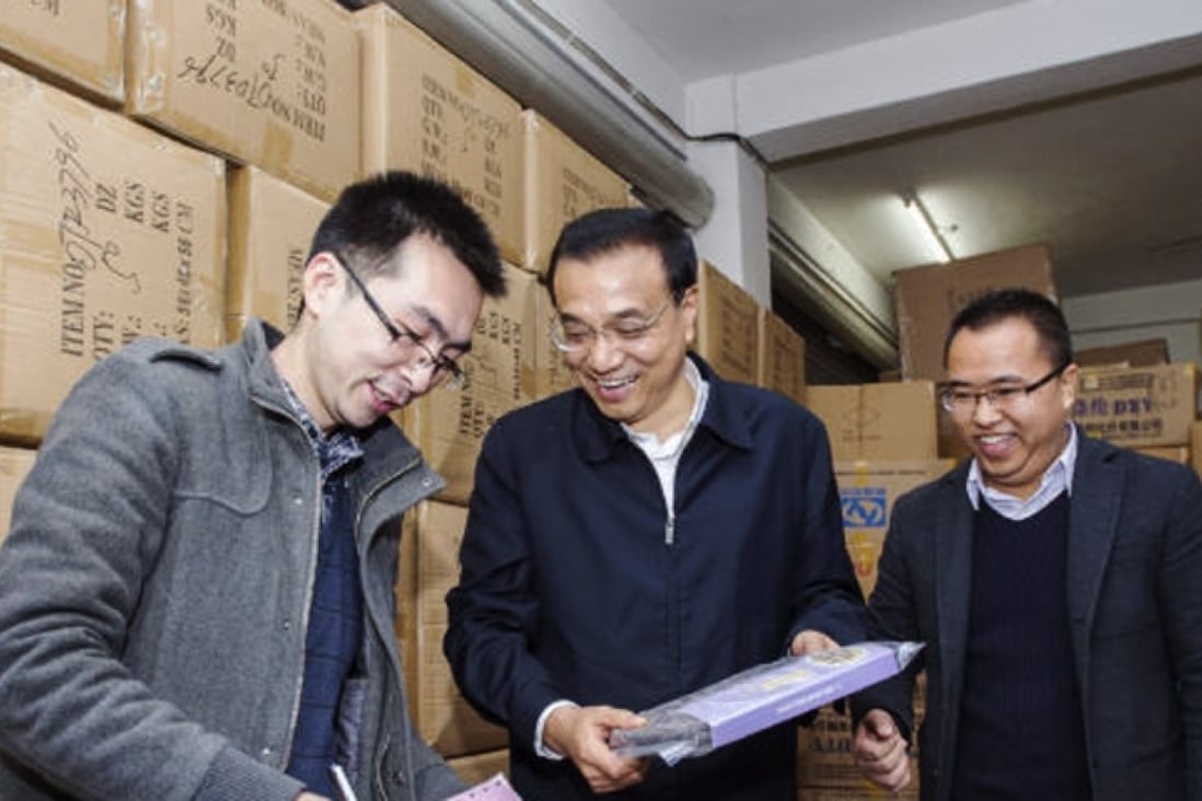 Chinese Premier Li Keqiang (centre) visits an e-commerce store in Qingyanliu village. Photo: SCMP Pictures