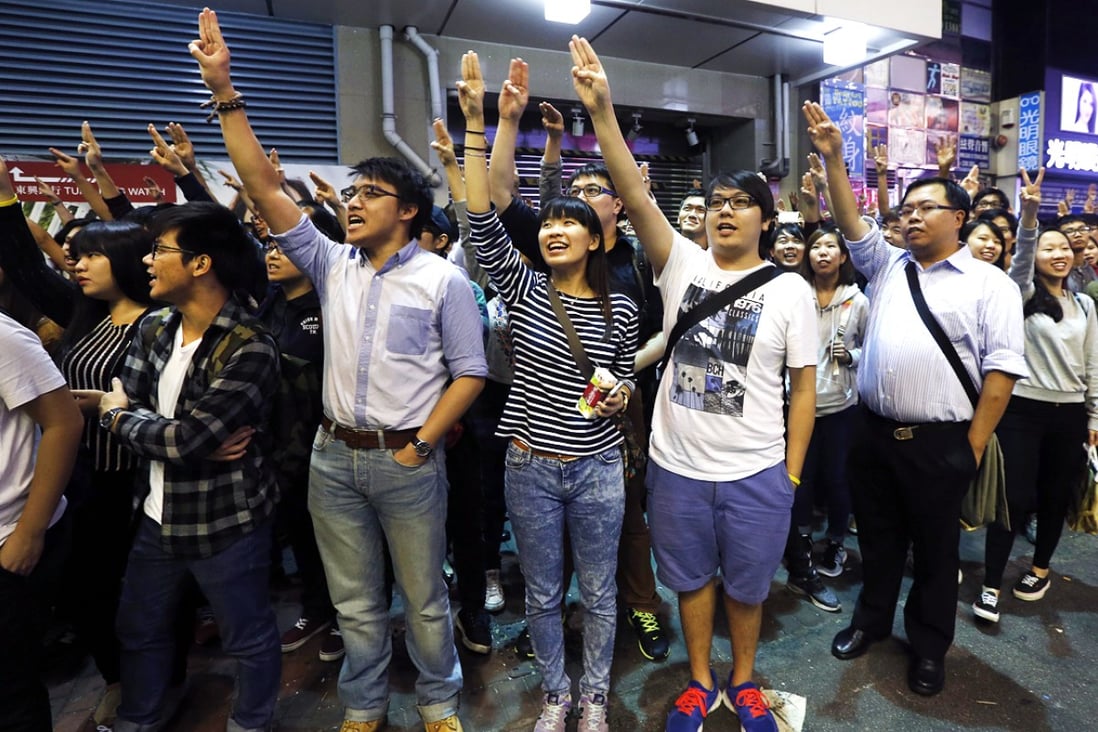 Protesters imitate a three-finger salute from movie "The Hunger Games", during a rally at Mong Kok. Photo: Reuters